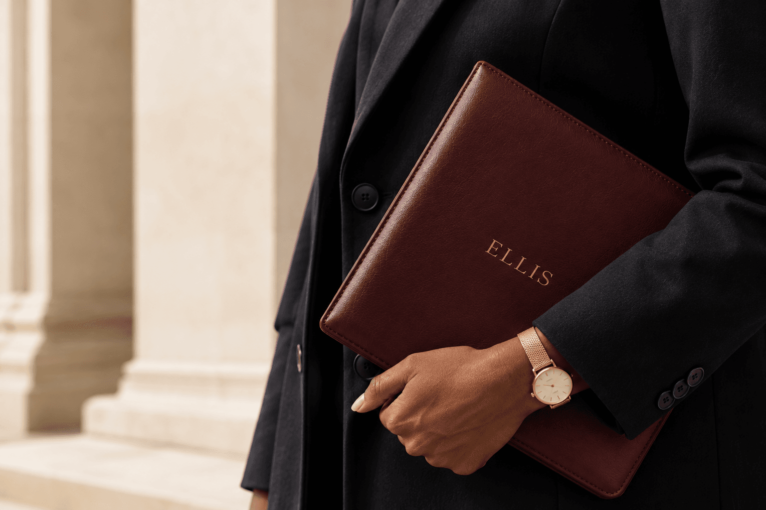 An ELLIS folio held with quiet confidence, set against classical architecture